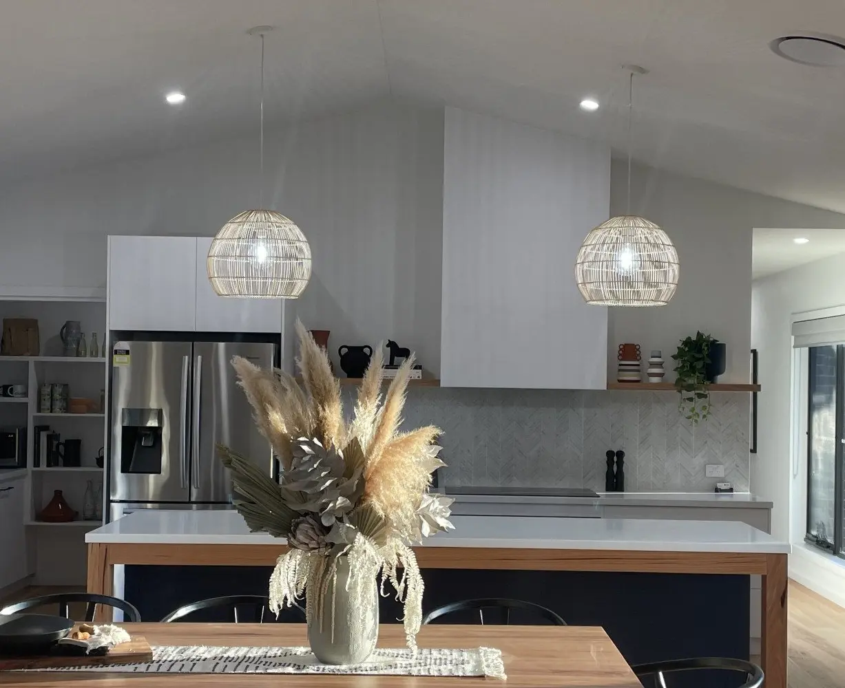 Rattan pendant lights over a kitchen island and dining table